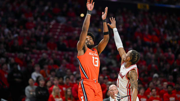 Illinois Fighting Illini forward Quincy Guerrier (13) shoots over Maryland Terrapins guard Jahmir Young (1) during the first half at Xfinity Center.